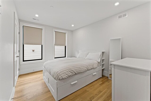 bedroom with light wood-style floors, recessed lighting, and baseboards