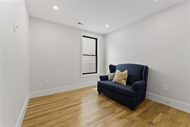 sitting room with light wood-style flooring, baseboards, and recessed lighting