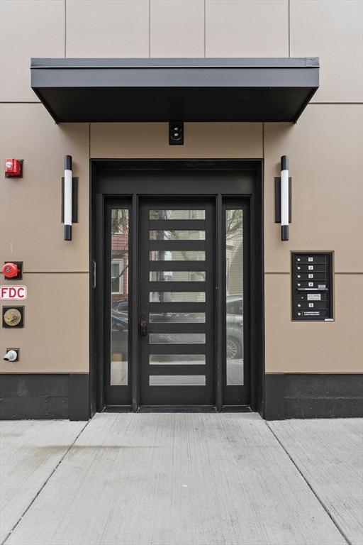 property entrance featuring stucco siding