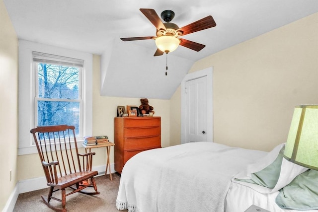 carpeted bedroom featuring a closet, vaulted ceiling, and ceiling fan