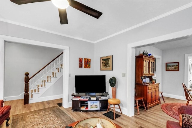 living room featuring ornamental molding and light hardwood / wood-style flooring