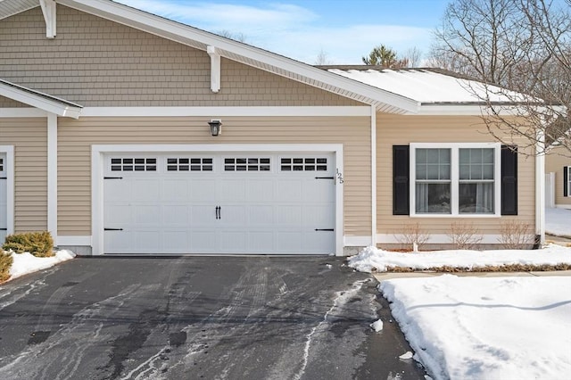 exterior space featuring aphalt driveway and a garage