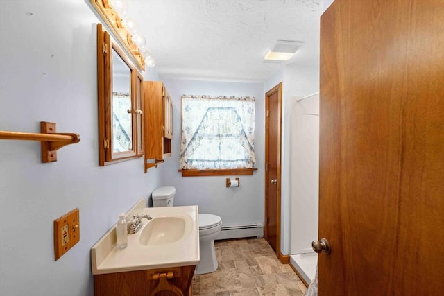 bathroom featuring a textured ceiling, a baseboard radiator, vanity, and toilet