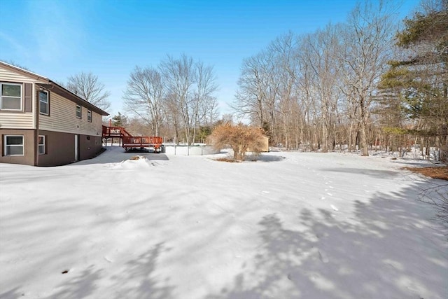 snowy yard with a deck