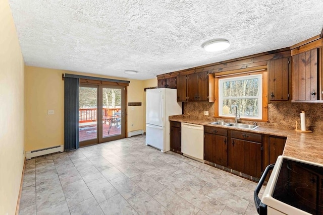 kitchen featuring a baseboard radiator, white appliances, a sink, light countertops, and decorative backsplash