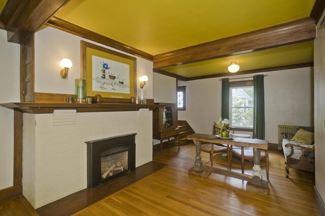104 Longmeadow St, Longmeadow, MA 01106 - dining space with wood finished floors, beamed ceiling, and a brick fireplace