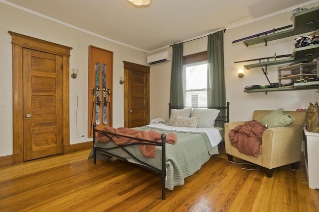 104 Longmeadow St, Longmeadow, MA 01106 - bedroom with wood-type flooring, crown molding, and a wall mounted air conditioner