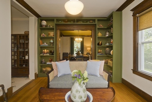 104 Longmeadow St, Longmeadow, MA 01106 - sitting room featuring wood finished floors, built in features, and crown molding