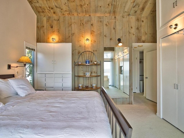 bedroom with carpet floors, wooden ceiling, wood walls, and high vaulted ceiling
