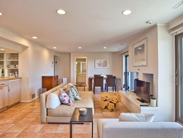 living room with recessed lighting, light tile patterned floors, and ornamental molding