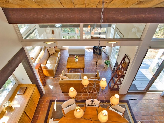 tiled living room with a towering ceiling and wooden ceiling