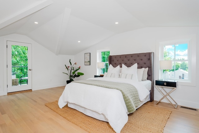 bedroom featuring access to exterior, multiple windows, light hardwood / wood-style flooring, and vaulted ceiling