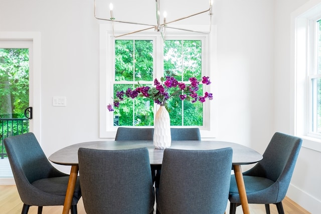 dining area featuring light hardwood / wood-style flooring, a chandelier, and plenty of natural light