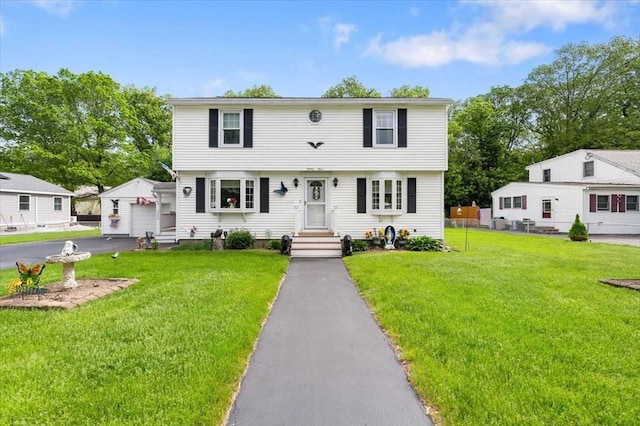 34 Robert Bigelow St, Chelmsford, MA 01824 - colonial-style house with a front yard and a detached garage