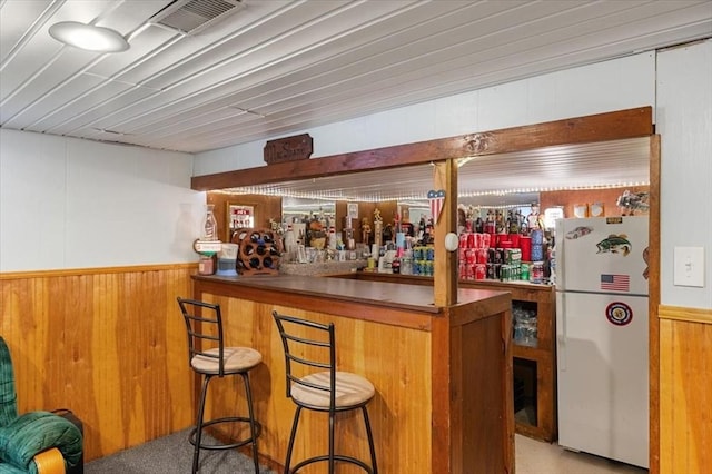 34 Robert Bigelow St, Chelmsford, MA 01824 - indoor dry bar with freestanding refrigerator, wooden walls, and wainscoting