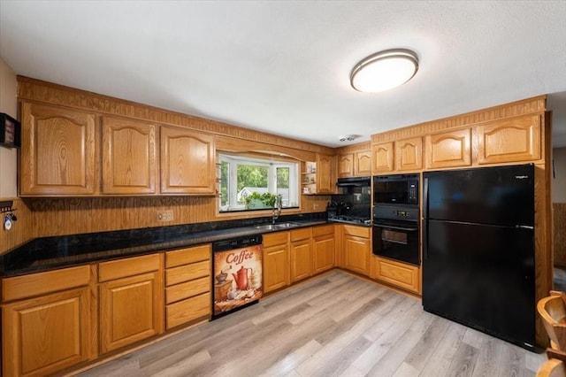 34 Robert Bigelow St, Chelmsford, MA 01824 - kitchen featuring black appliances, a sink, light wood-style flooring, and dark countertops
