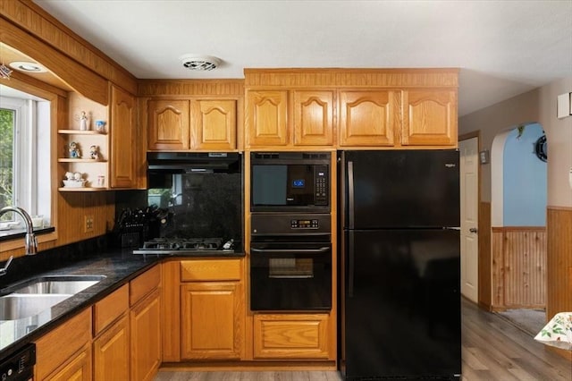 34 Robert Bigelow St, Chelmsford, MA 01824 - kitchen with black appliances, a sink, under cabinet range hood, light wood-style flooring, and wainscoting