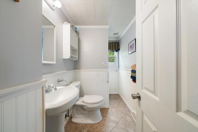 34 Robert Bigelow St, Chelmsford, MA 01824 - bathroom with crown molding, toilet, tile patterned floors, and wainscoting