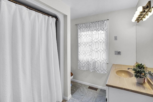 bathroom with toilet and vanity