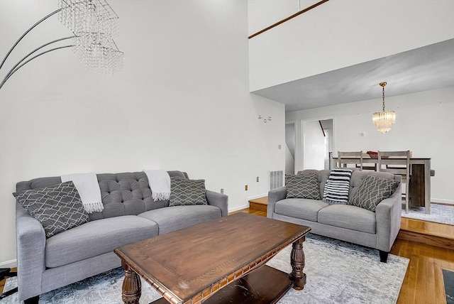 living room featuring hardwood / wood-style floors and an inviting chandelier