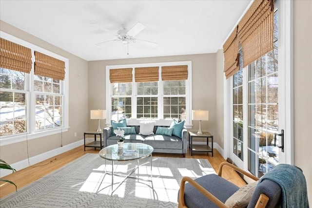 sunroom / solarium with a ceiling fan