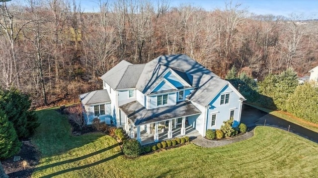 birds eye view of property with a view of trees