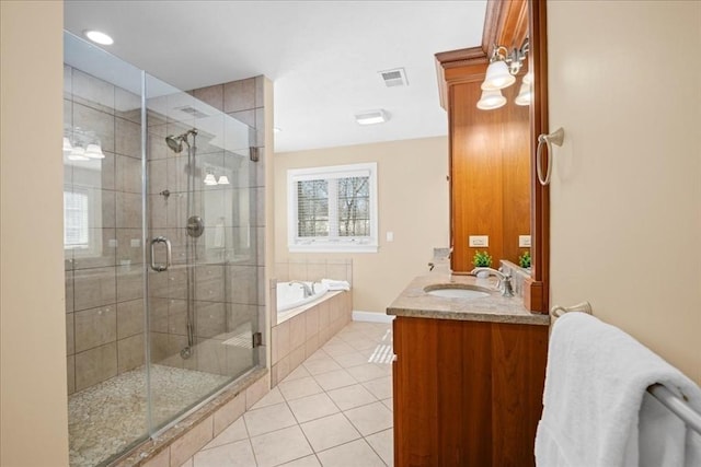 bathroom featuring tile patterned flooring, a sink, visible vents, and a shower stall