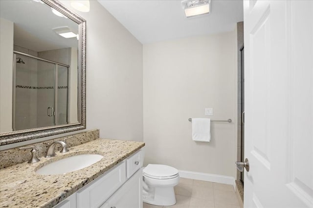 full bath featuring toilet, vanity, baseboards, tile patterned floors, and a stall shower