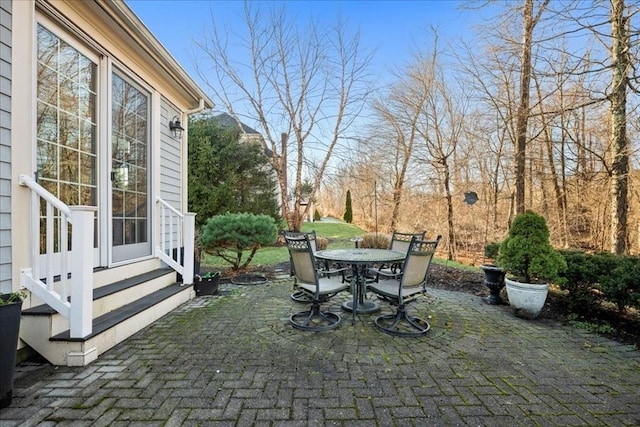 view of patio featuring entry steps and outdoor dining area