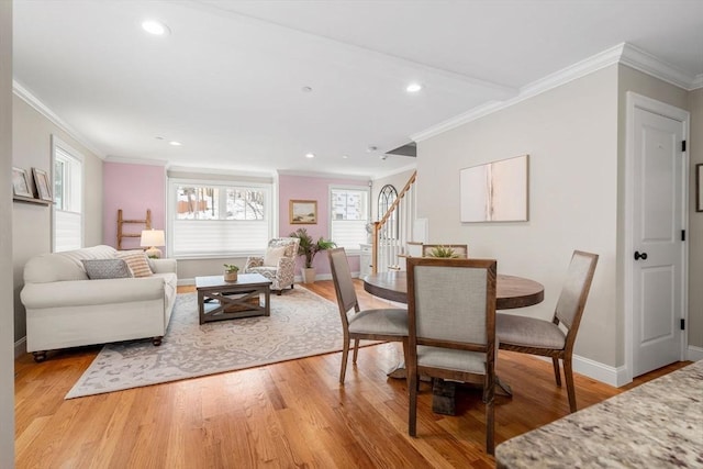 dining area featuring ornamental molding and light wood-type flooring