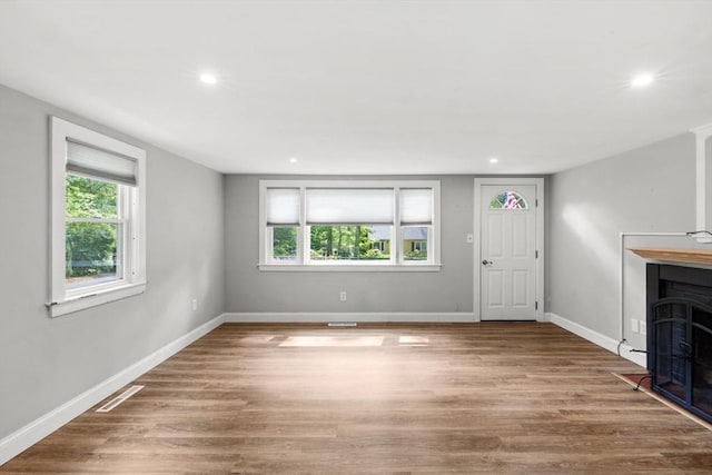 42 Deer Hollow Rd, Sandwich, MA 02644 - unfurnished living room with wood finished floors, plenty of natural light, recessed lighting, and a fireplace