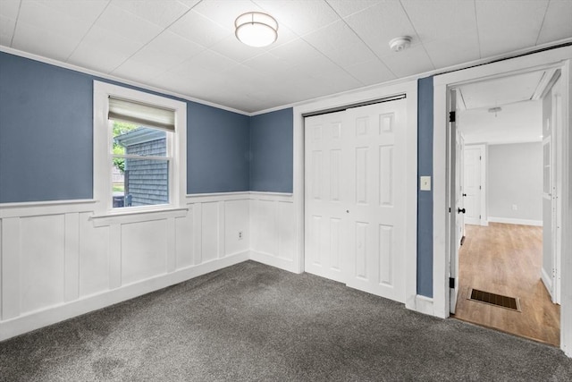 42 Deer Hollow Rd, Sandwich, MA 02644 - unfurnished bedroom featuring attic access, carpet flooring, a closet, wainscoting, and ornamental molding