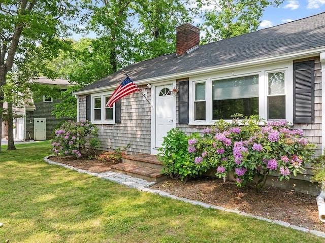 42 Deer Hollow Rd, Sandwich, MA 02644 - view of front facade featuring a chimney, a front yard, and a shingled roof