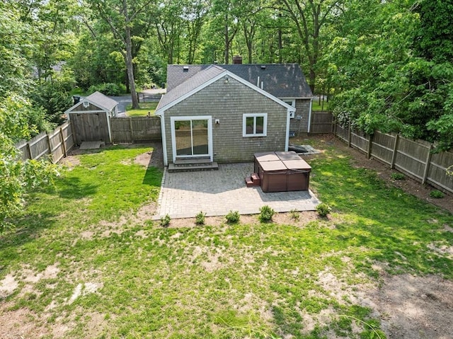 42 Deer Hollow Rd, Sandwich, MA 02644 - back of property featuring a patio area, a fenced backyard, a hot tub, and a chimney