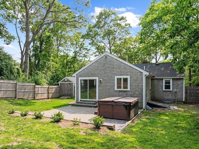42 Deer Hollow Rd, Sandwich, MA 02644 - back of house featuring a hot tub, a patio area, a fenced backyard, and a chimney