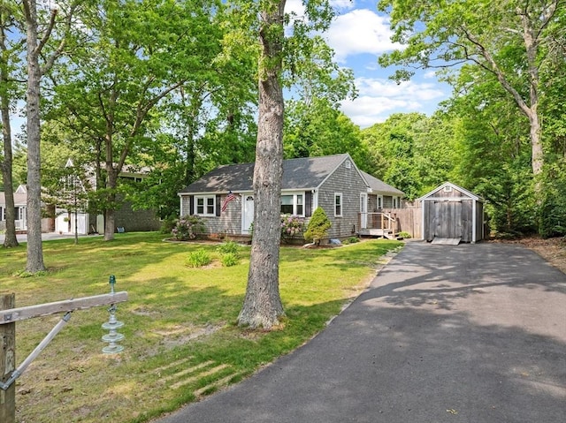 42 Deer Hollow Rd, Sandwich, MA 02644 - single story home with asphalt driveway, a shed, a garage, and a front yard