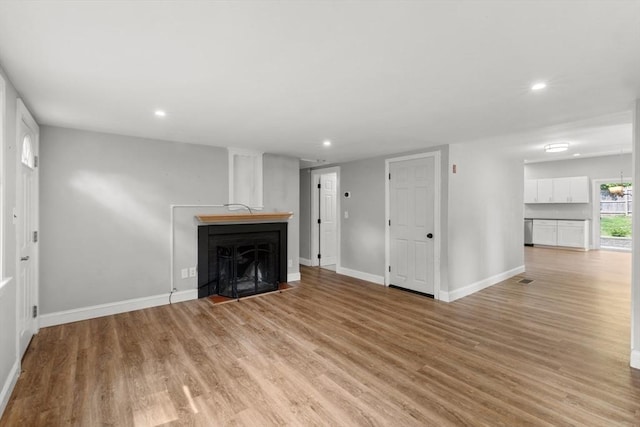 42 Deer Hollow Rd, Sandwich, MA 02644 - unfurnished living room with light wood-style flooring, recessed lighting, and a fireplace