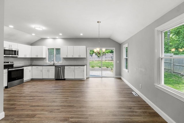 42 Deer Hollow Rd, Sandwich, MA 02644 - kitchen featuring stainless steel appliances, lofted ceiling, dark countertops, healthy amount of natural light, and recessed lighting