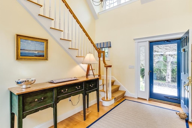 86 Champlain, Chatham, MA 02633 - foyer with stairs, light wood-type flooring, a high ceiling, and a chandelier