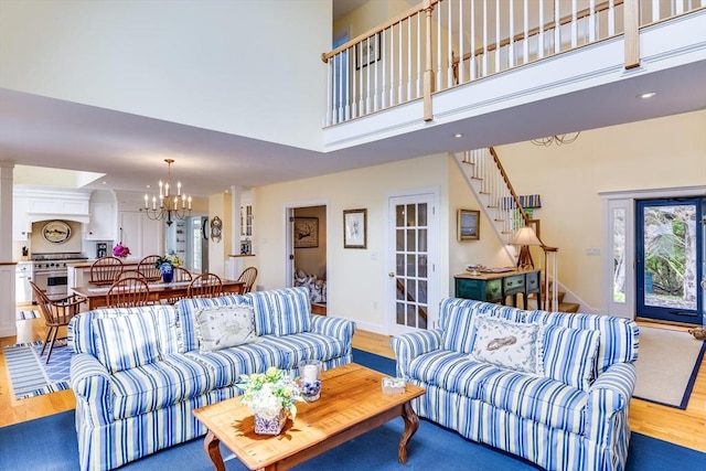 86 Champlain, Chatham, MA 02633 - living area with a chandelier, wood finished floors, a towering ceiling, and stairway