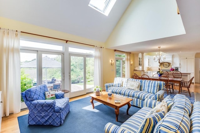 86 Champlain, Chatham, MA 02633 - living room with a chandelier, light wood-style flooring, healthy amount of natural light, high vaulted ceiling, and a skylight