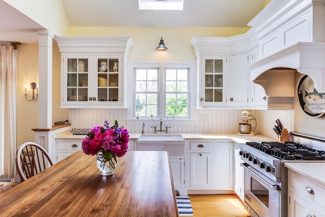 86 Champlain, Chatham, MA 02633 - kitchen featuring stainless steel range, white cabinets, and wood counters