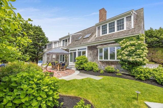 86 Champlain, Chatham, MA 02633 - rear view of property with a balcony, a yard, a patio area, and a chimney
