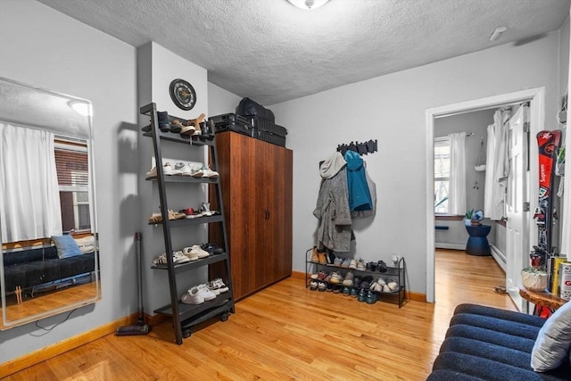 25 Sheafe St, Boston, MA 02113 - interior space featuring wood finished floors, a textured ceiling, baseboards, and a baseboard radiator