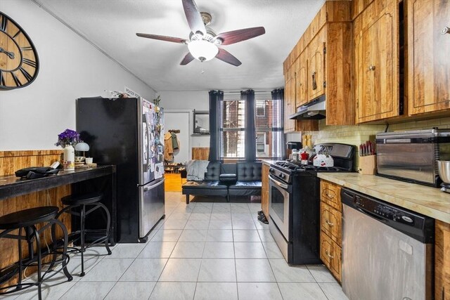 25 Sheafe St, Boston, MA 02113 - kitchen featuring appliances with stainless steel finishes, a ceiling fan, under cabinet range hood, light countertops, and brown cabinets
