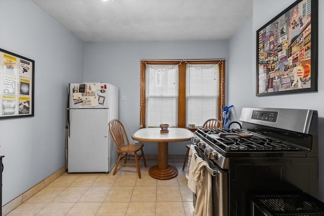 25 Sheafe St, Boston, MA 02113 - kitchen with freestanding refrigerator, stainless steel range with gas stovetop, baseboards, and light tile patterned flooring