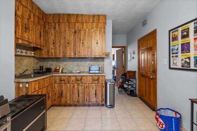 25 Sheafe St, Boston, MA 02113 - kitchen featuring brown cabinets, backsplash, light countertops, and a sink