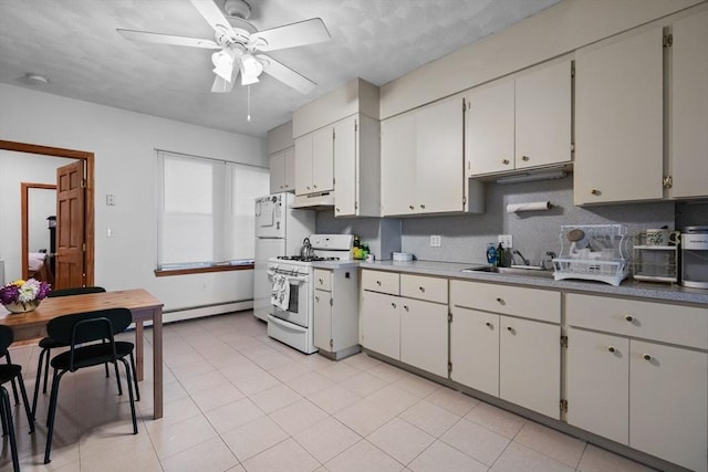 25 Sheafe St, Boston, MA 02113 - kitchen with white gas stove, a sink, a ceiling fan, a baseboard radiator, and under cabinet range hood