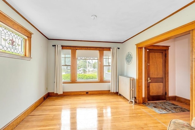 17 Matchett St, Boston, MA 02135 - empty room featuring radiator heating unit, crown molding, light wood-style floors, and baseboards