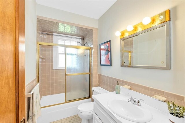 17 Matchett St, Boston, MA 02135 - bathroom with vanity, toilet, combined bath / shower with glass door, tile walls, and tile patterned floors